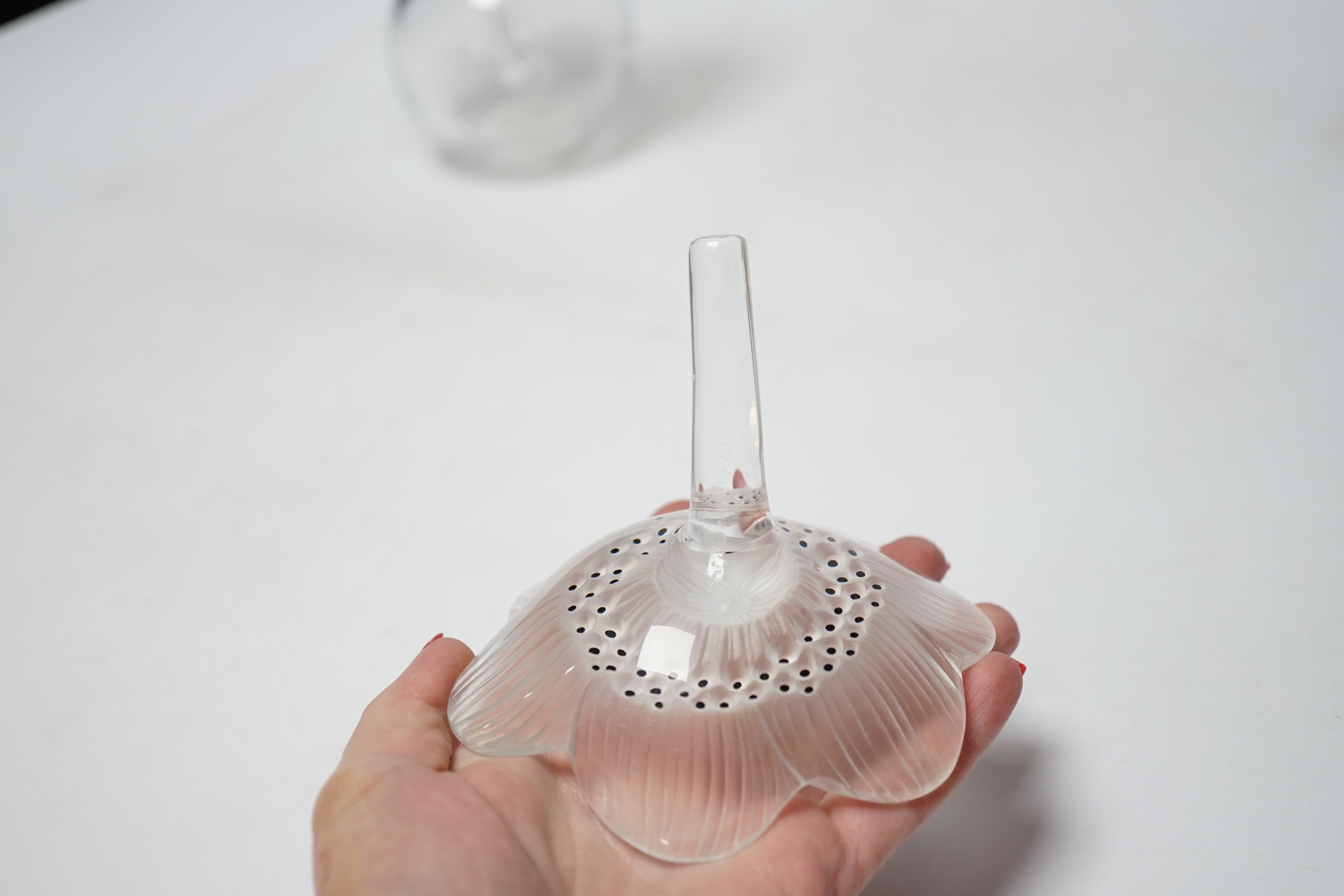 A Lalique anemone glass scent bottle and stopper, signed to the base, together with an associated anemone stopper, 16cm high